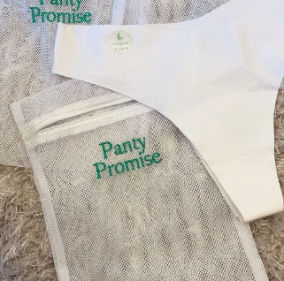 White color organic womans panty next to panty promise wash bags